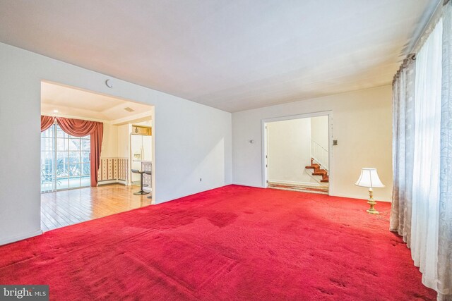 living area with carpet flooring and a baseboard heating unit