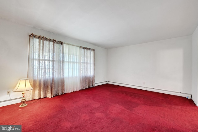 carpeted spare room with baseboard heating