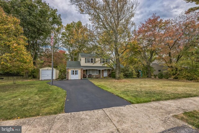 view of front of property featuring an outdoor structure, a garage, and a porch