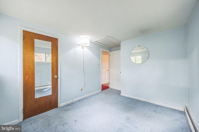 unfurnished room featuring carpet and a baseboard heating unit