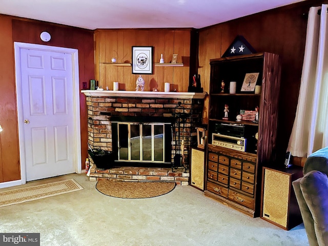 carpeted living room featuring wooden walls and a brick fireplace