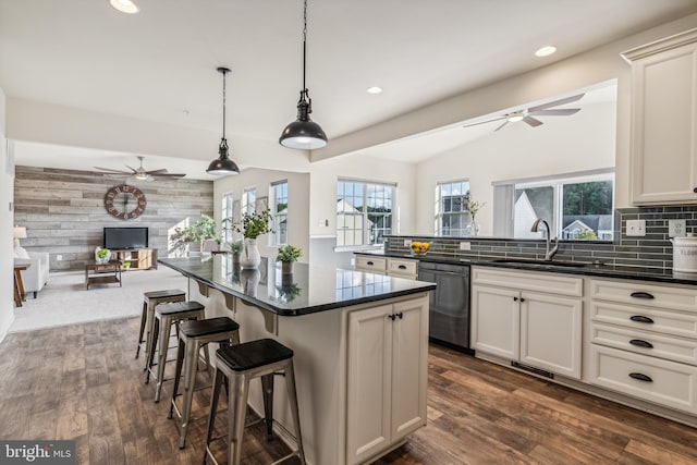 kitchen with dark wood-type flooring, dishwasher, pendant lighting, a center island, and ceiling fan