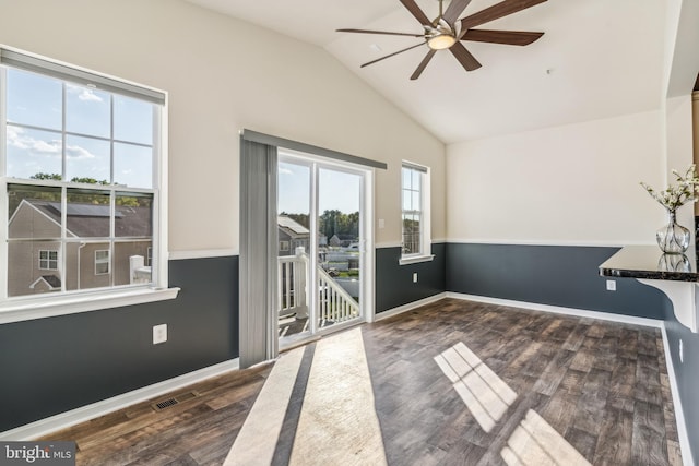 spare room with vaulted ceiling, dark hardwood / wood-style floors, and ceiling fan