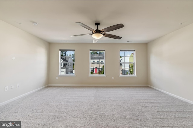 carpeted empty room featuring ceiling fan