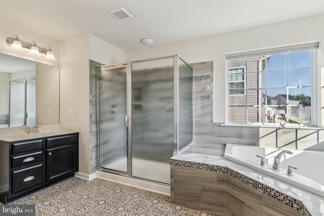 bathroom featuring vanity and separate shower and tub