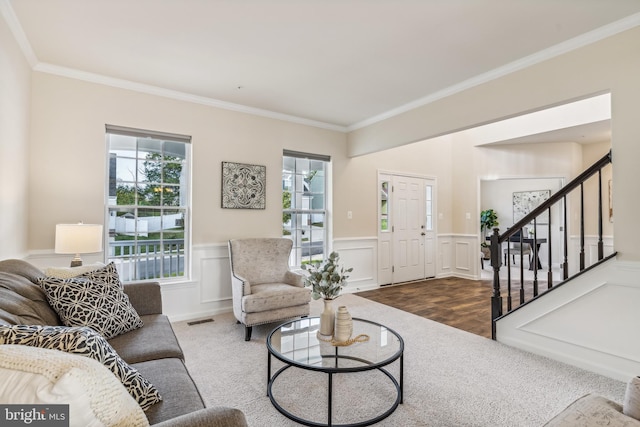 living room with crown molding and hardwood / wood-style floors