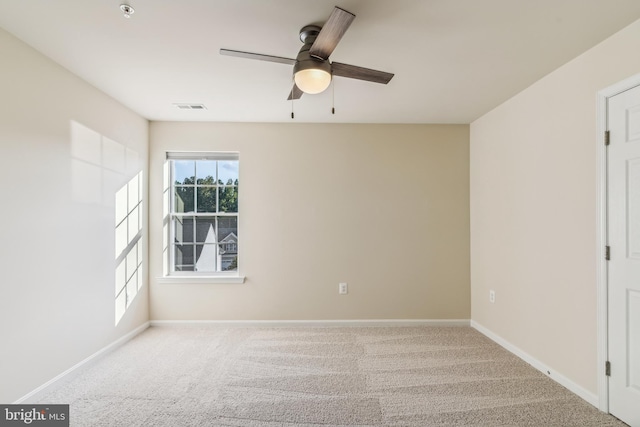 carpeted empty room featuring ceiling fan