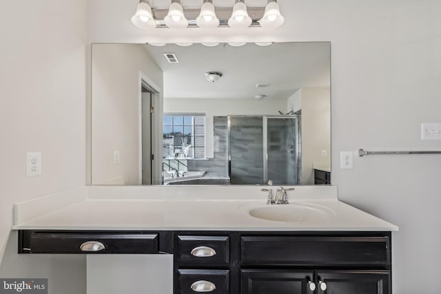 bathroom with walk in shower and vanity