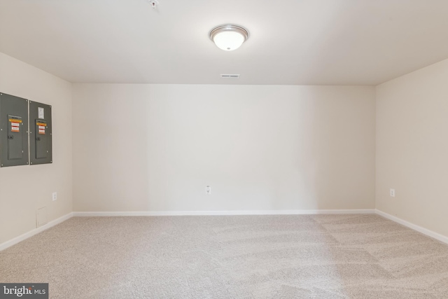 carpeted spare room featuring electric panel