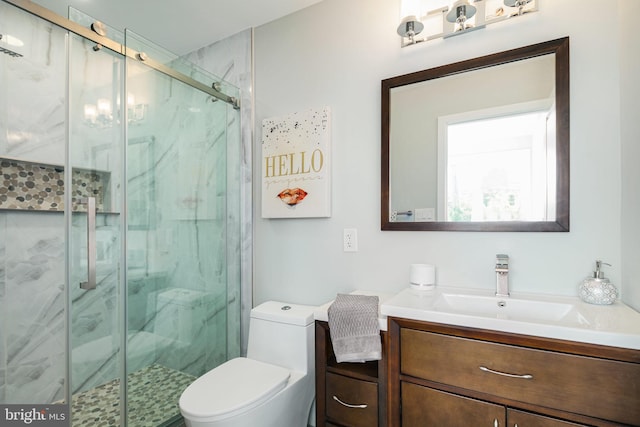 bathroom with walk in shower, vanity, and toilet