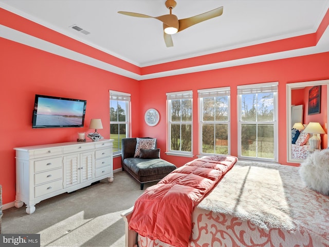 bedroom with multiple windows, light colored carpet, ceiling fan, and crown molding