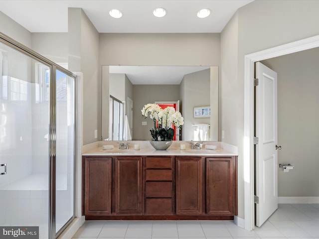 bathroom featuring tile patterned flooring, a shower with door, and vanity