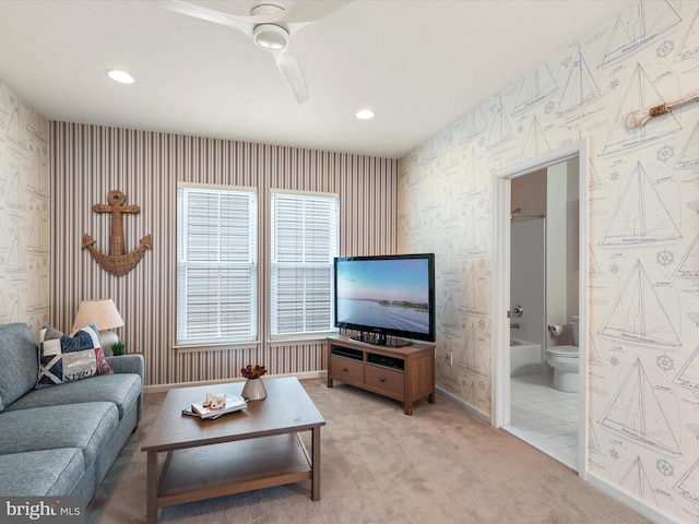 carpeted living room featuring ceiling fan