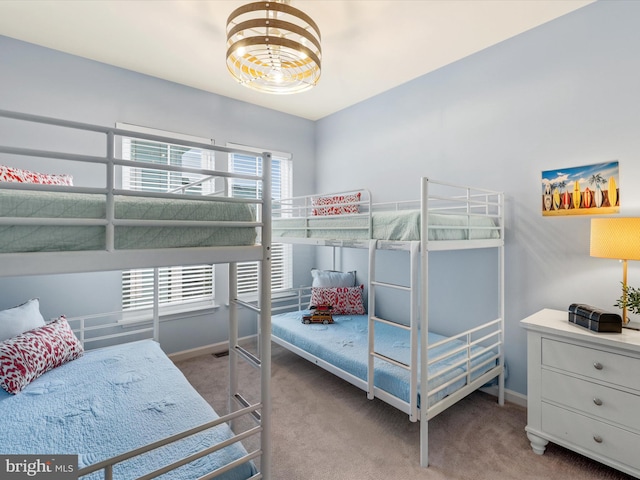 carpeted bedroom featuring multiple windows