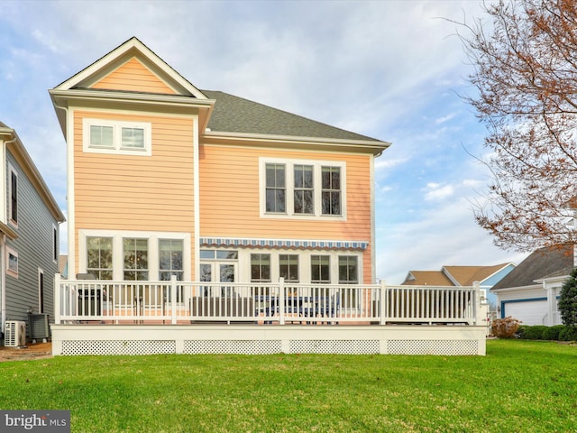 back of property with a wooden deck, central AC, and a lawn