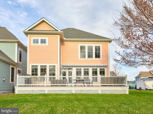 back of house with a wooden deck and a yard