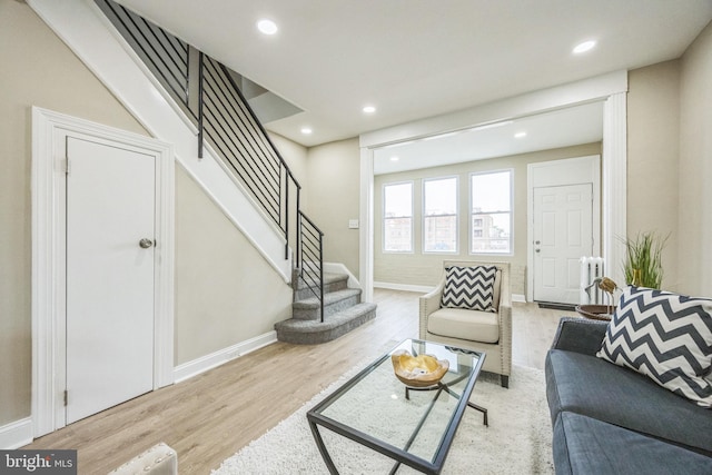 living room with light wood-type flooring and radiator