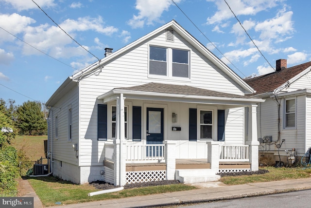 bungalow featuring a porch and central AC