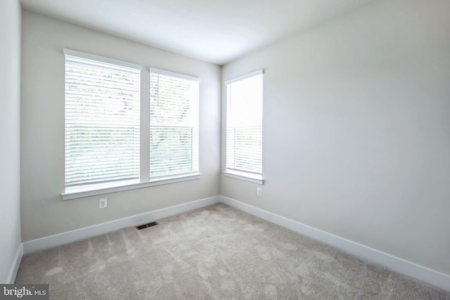 empty room featuring light colored carpet