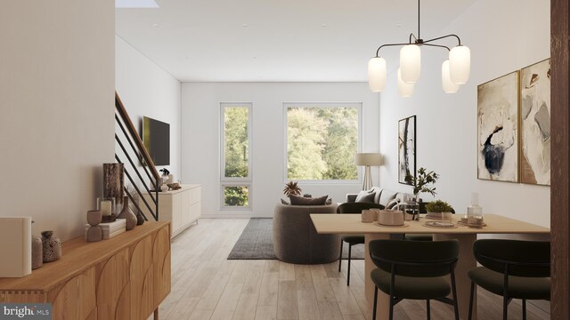 kitchen with a kitchen island, decorative light fixtures, light hardwood / wood-style floors, and white cabinetry