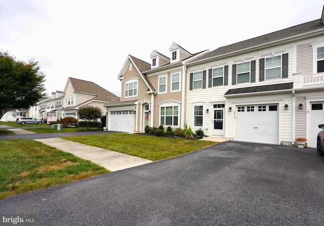 multi unit property featuring a garage and a front lawn