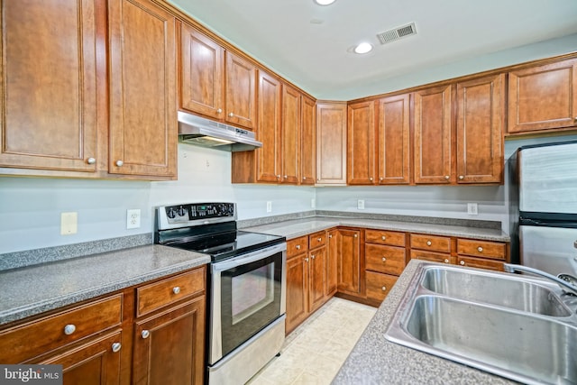 kitchen with light tile patterned flooring, stainless steel appliances, and sink