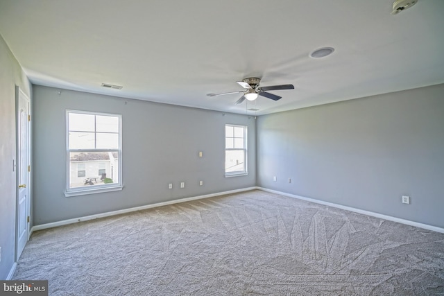 carpeted spare room featuring ceiling fan