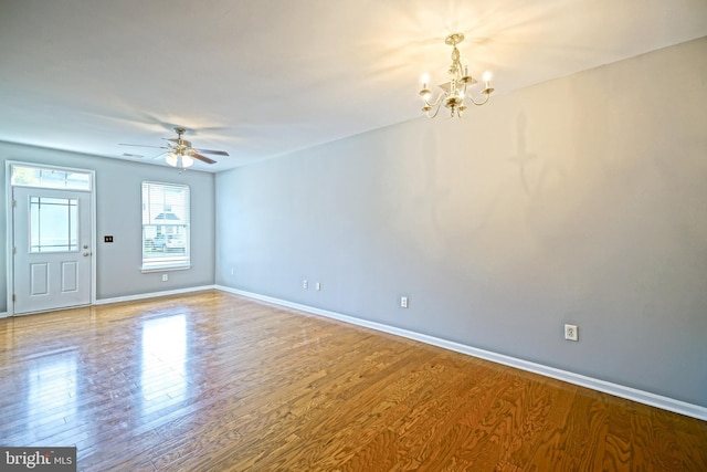 interior space with wood-type flooring and ceiling fan with notable chandelier