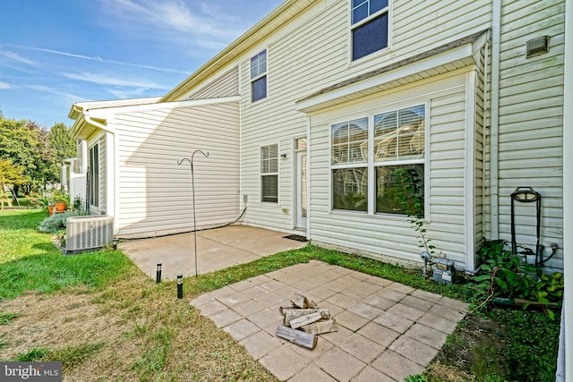 rear view of house with a patio area and central AC unit