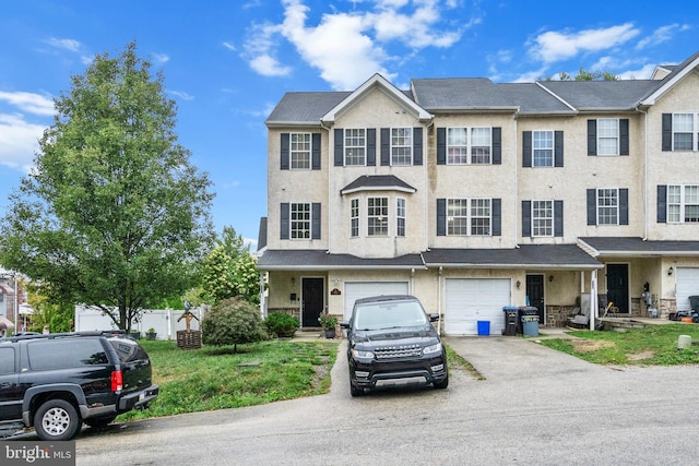 townhome / multi-family property featuring a garage