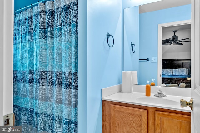 bathroom featuring vanity, ceiling fan, and a shower with curtain