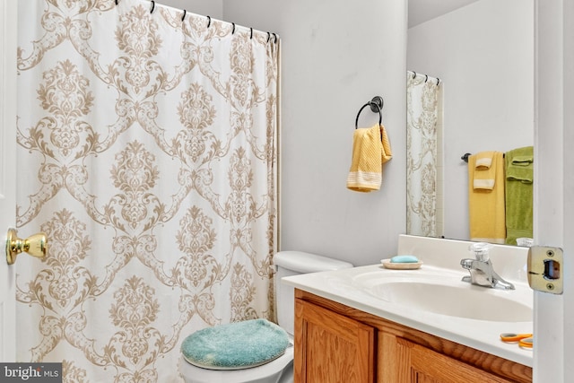 bathroom featuring vanity and toilet