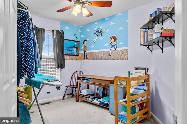 bedroom featuring ceiling fan and carpet