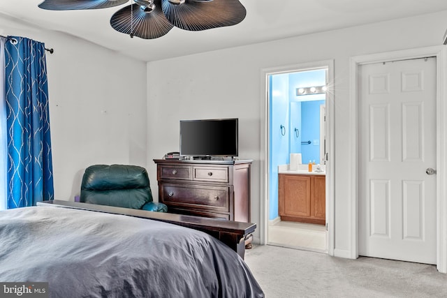 bedroom with connected bathroom, ceiling fan, and light colored carpet