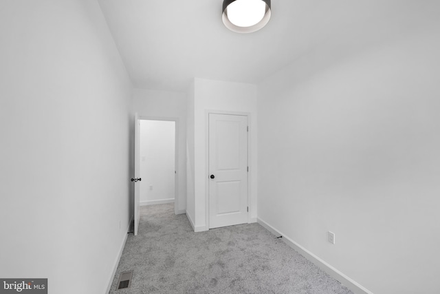 interior space featuring light colored carpet