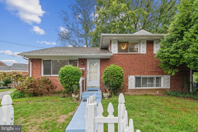 split level home with a front yard