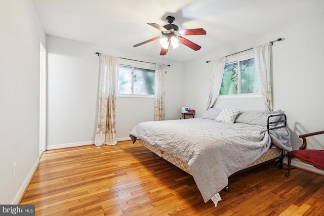 bedroom with ceiling fan and hardwood / wood-style flooring