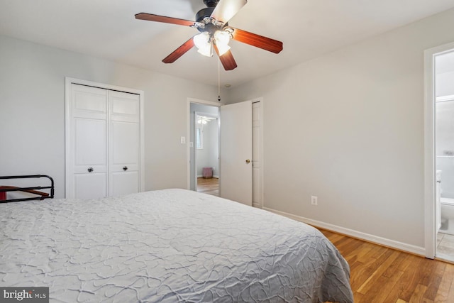 bedroom with wood-type flooring, ceiling fan, and ensuite bathroom