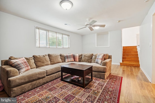 living room featuring ceiling fan and light wood-type flooring