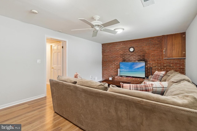 living room featuring ceiling fan and light hardwood / wood-style floors