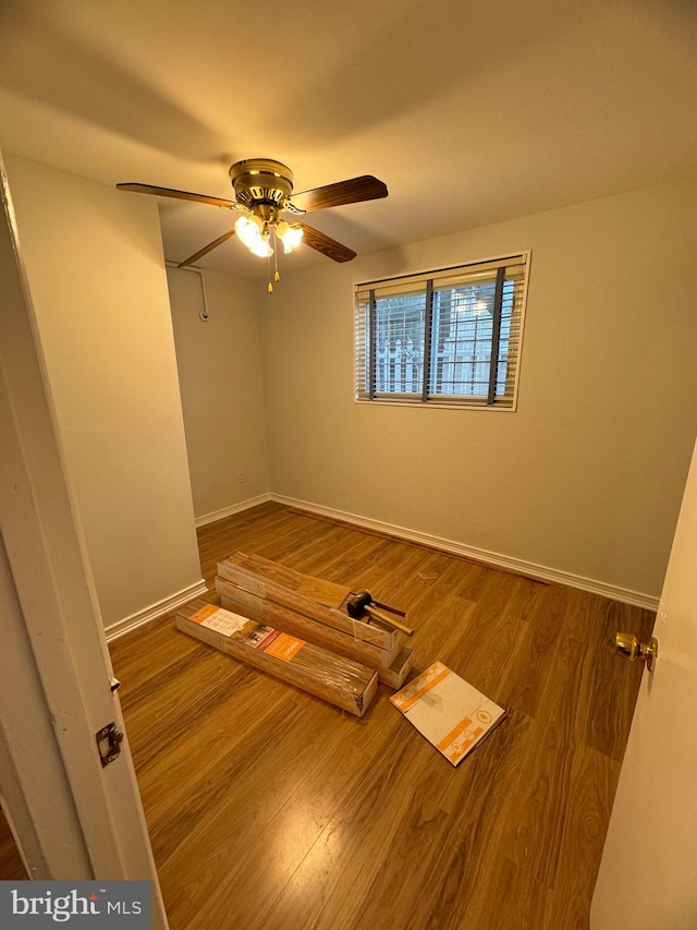 unfurnished room featuring ceiling fan and hardwood / wood-style floors