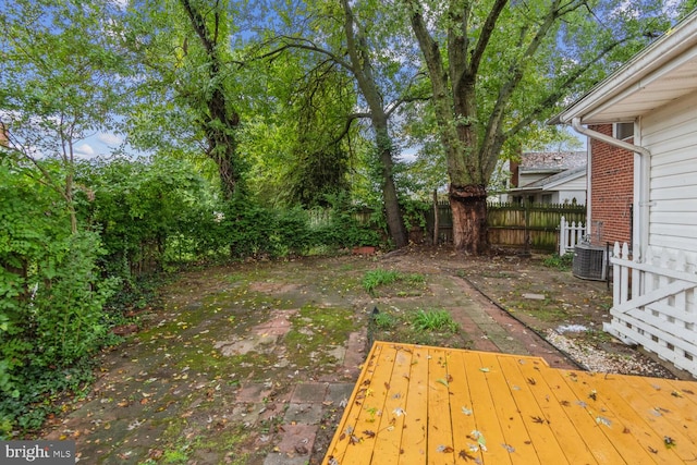 view of yard with central AC unit and a patio