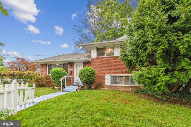 tri-level home with a front yard