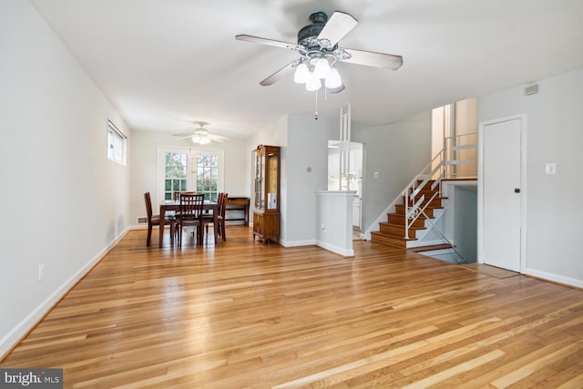 unfurnished dining area with ceiling fan and light hardwood / wood-style flooring