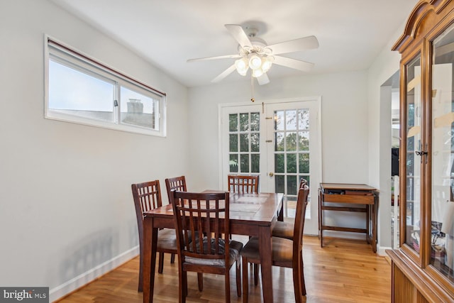 dining space featuring ceiling fan, french doors, and light hardwood / wood-style flooring