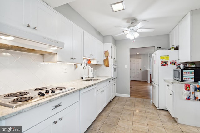 kitchen with white cabinetry, tasteful backsplash, white appliances, ceiling fan, and sink