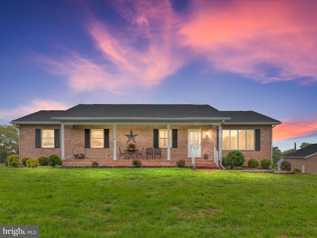 ranch-style home featuring a lawn