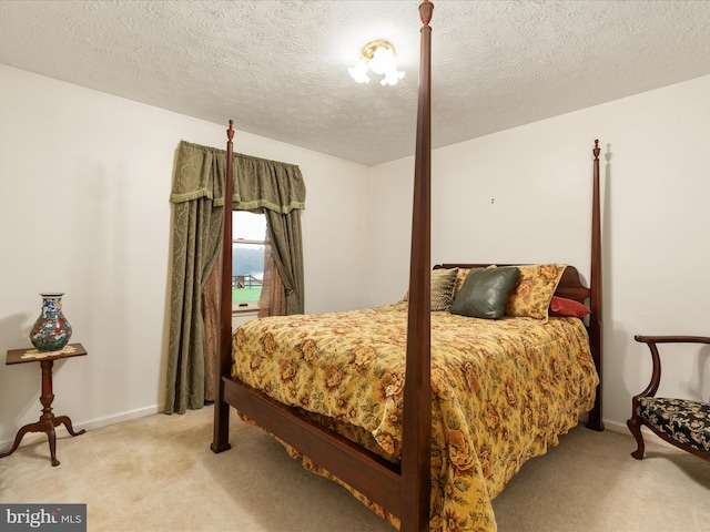 carpeted bedroom featuring a textured ceiling