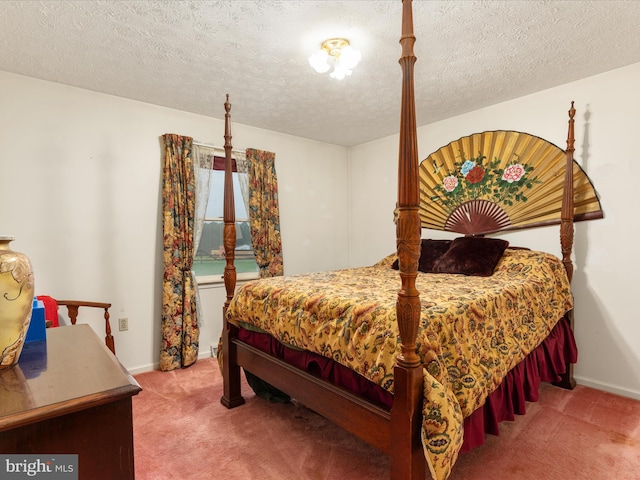 bedroom with a textured ceiling and carpet flooring