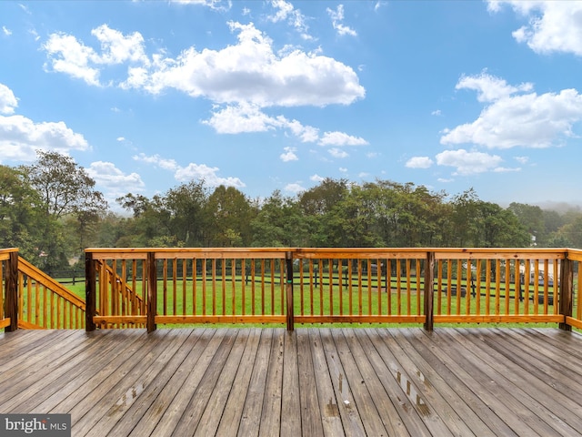 wooden terrace with a lawn